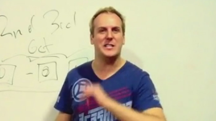 RG Dance school owner Grant Davies against a whiteboard with markings.