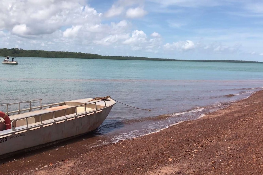 A small boat on the island's shore