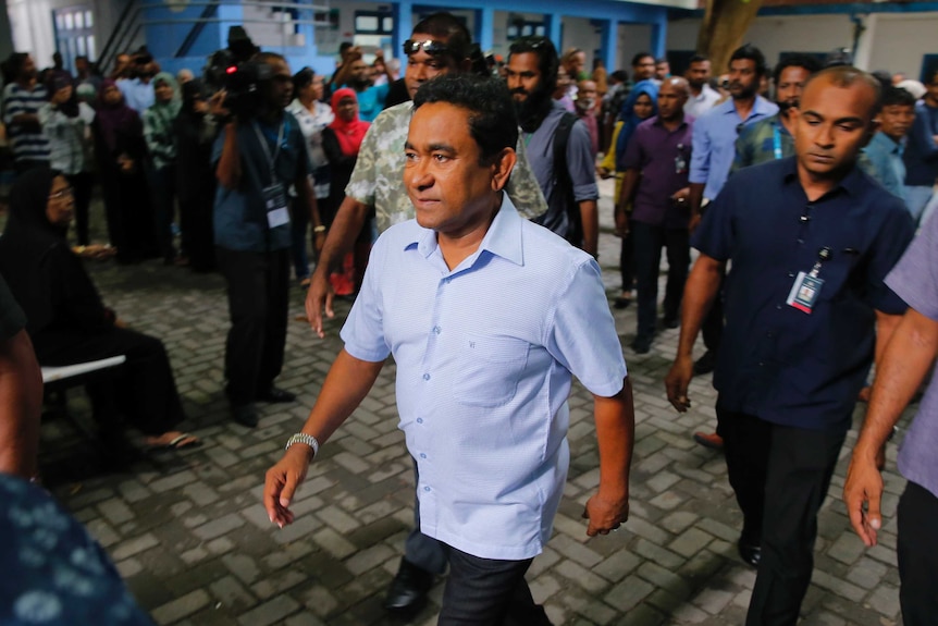 Maldivian president Yameen Abdul Gayoom leaves a polling station