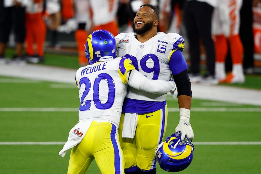 Two LA Rams players celebrate during the Super Bowl.