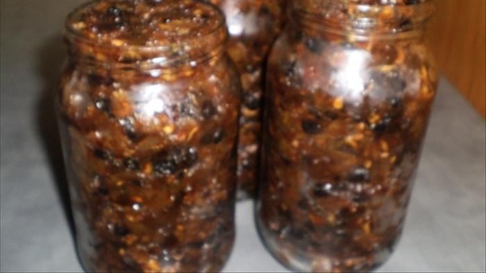 Jars of fruit mince with the lids off.
