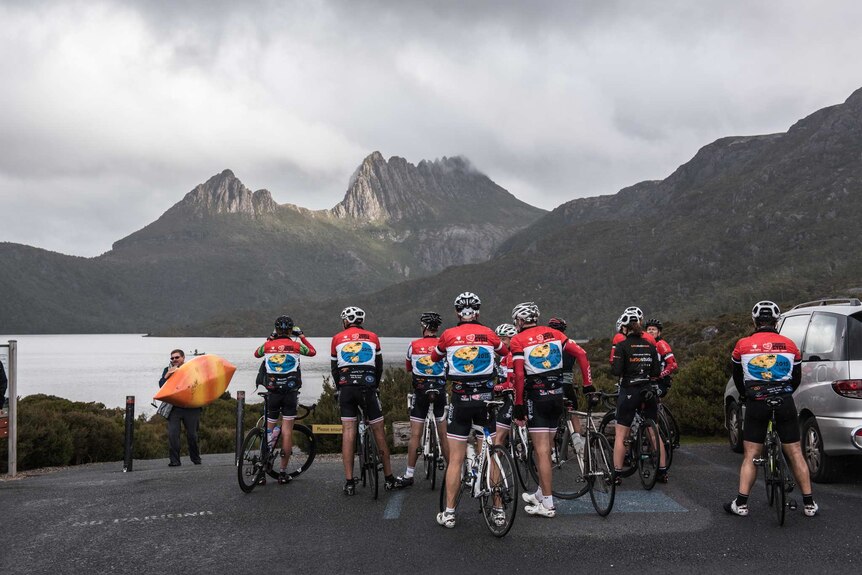 Riders on a charity fund-raiserfor Variety stop and look at Cradle Mountain.