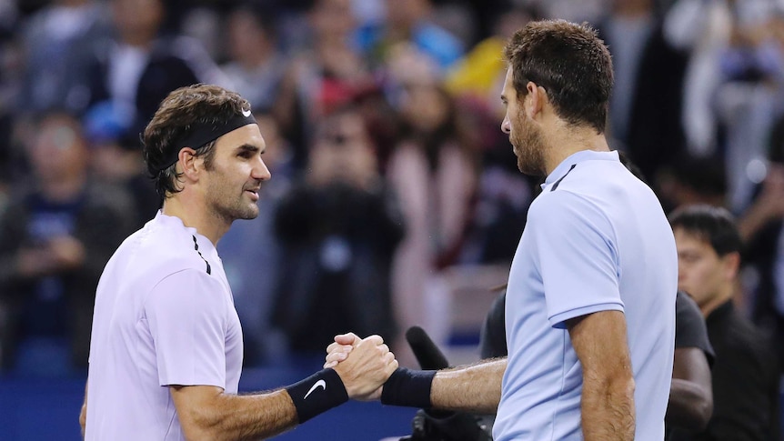 Roger Federer of Switzerland (L), shakes hands with Juan Martin del Potro after winning in Shanghai.