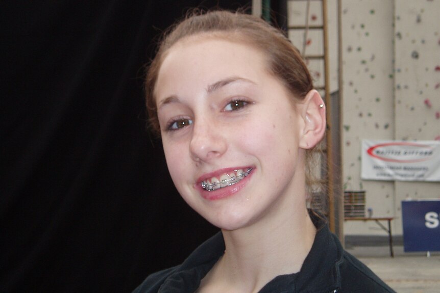 Libby Hall smiles with braces showing.