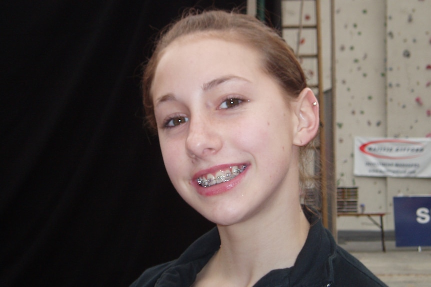 Libby Hall smiles with braces showing.