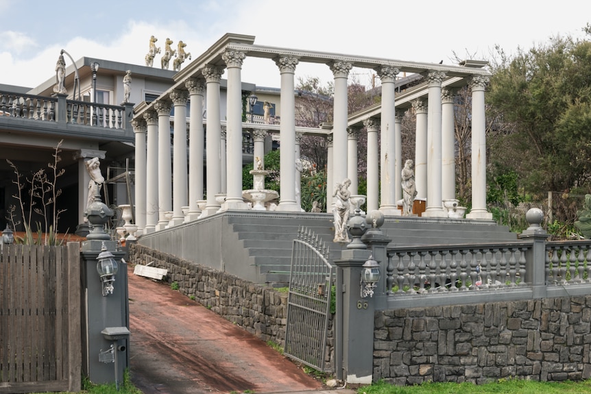 Image of a front yard with a large replica of the Parthenon built in it.