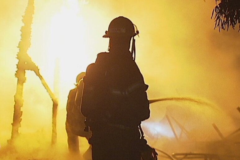 A firefighter battles flames