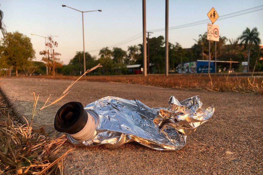 A cask wine bladder lying on a footpath