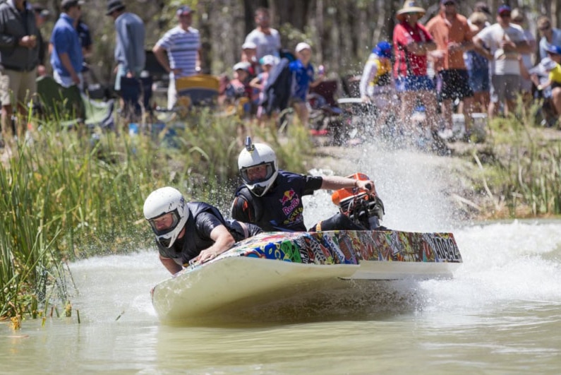 Dinghy Derby competitors race along a creek at Renmark