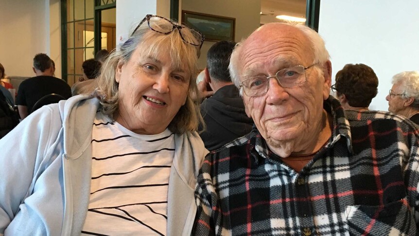 An elderly couple sitting in a restaurant