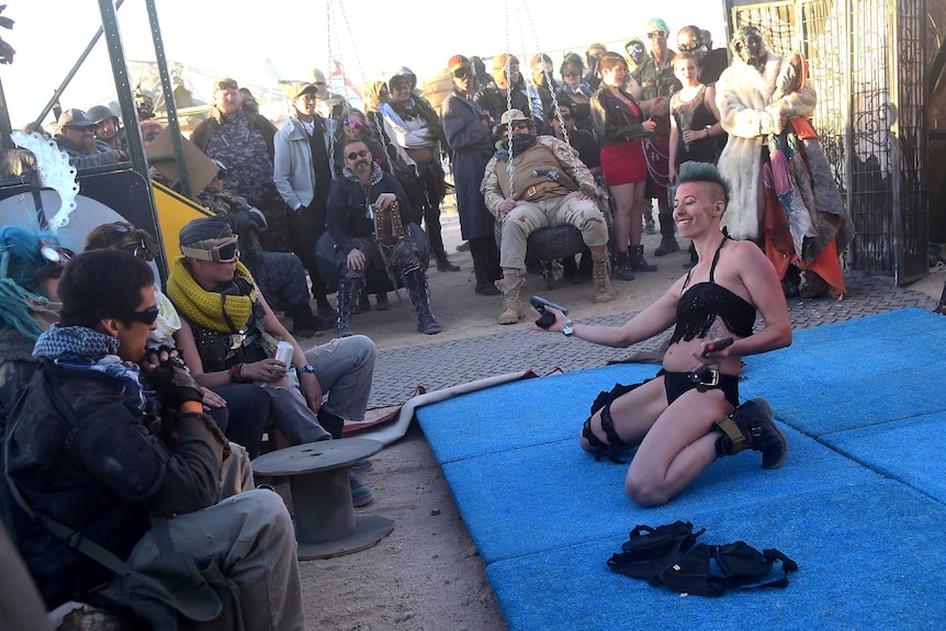 Festival goers enjoy a burlesque performance as people attend the first day of Wasteland Weekend.