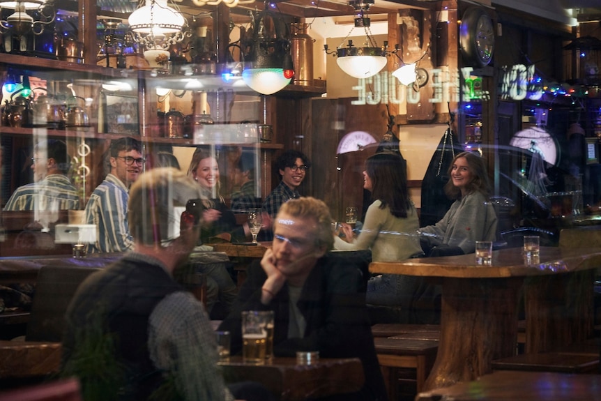 A view through a window of a busy Swedish bar