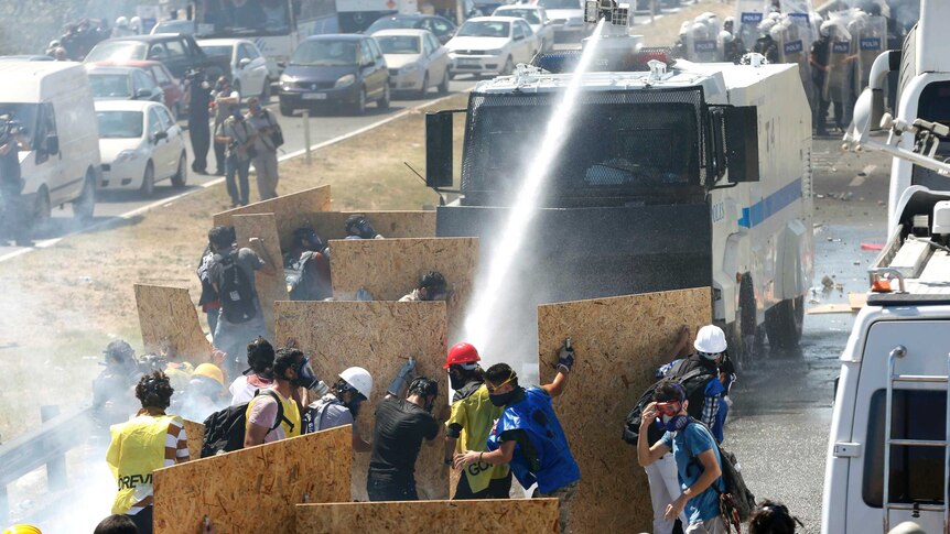Riot police use a water cannon and tear gas to disperse protesters in Silivri, Turkey.
