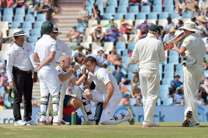 Ryan McLaren is helped after being hit by Mitchell Johnson