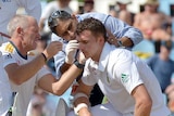 Ryan McLaren is helped after being hit by Mitchell Johnson