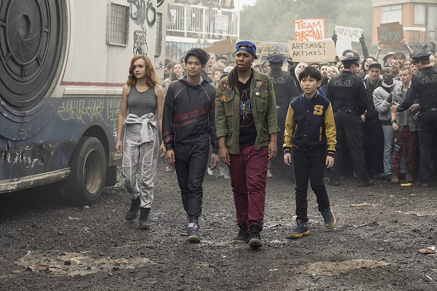 Colour still image from 2018 film Ready Player One of Lena Waithe, Win Morisaki, Olivia Cooke and Philip Zhao in a riot scene.