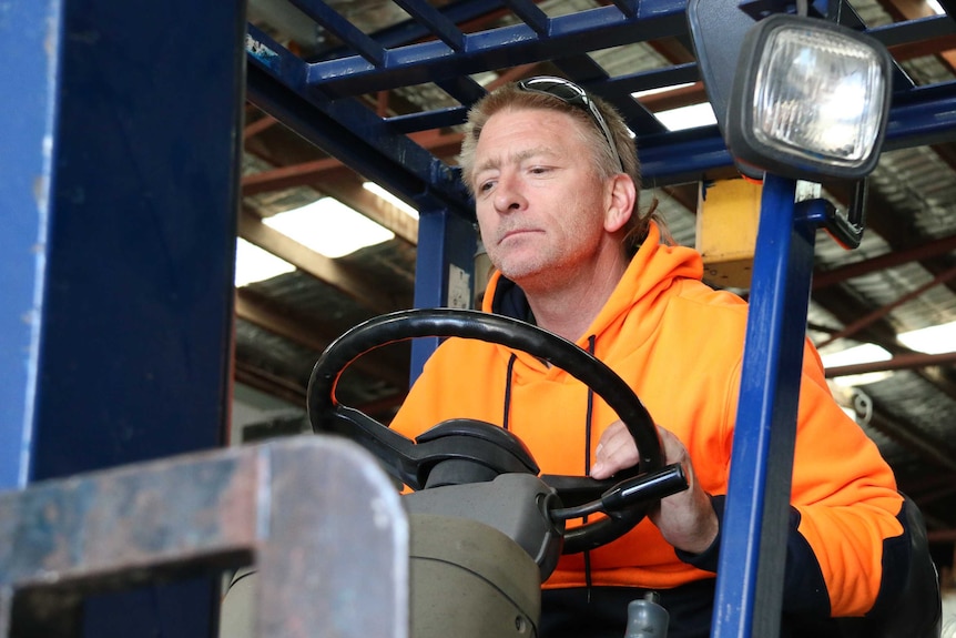 Jason Hawkins operates a forklift.