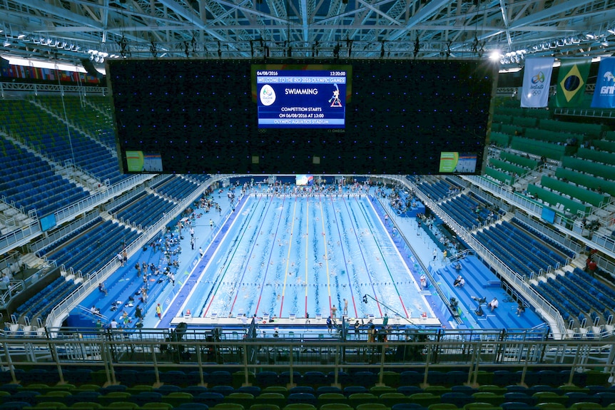 The Rio Olympics aquatic stadium, with the pool filled with swimmers 