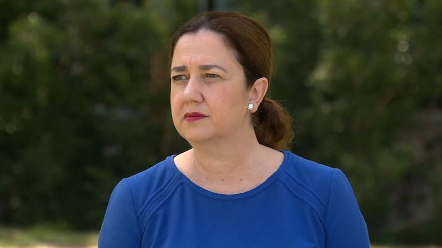 Annastacia Palaszczuk looks into the distance wearing a blue top