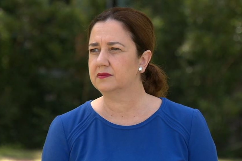 Annastacia Palaszczuk looks into the distance wearing a blue top