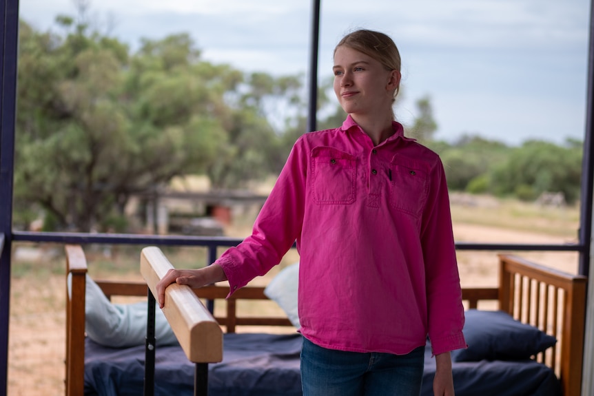 Lucy standing at a ballet bar on her verandah, north of Longreach, November 2023. 