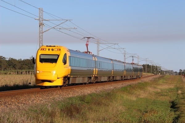 A train on a track running through a field. 