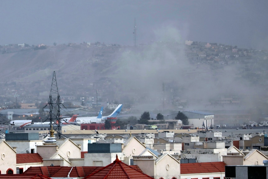 Smoke rises from a deadly explosion outside the airport in Kabul