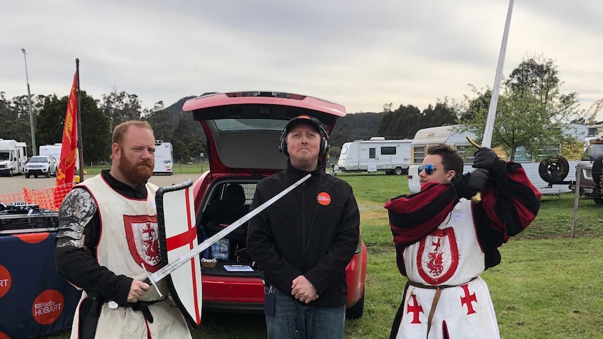 Joel Rheinberger is threatened by Knights at the Tasmanian Medieval Festival