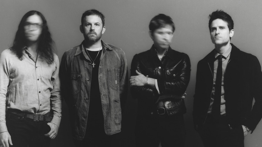 Black and white photo of the band Kings of Leon. Two faces are deliberately blurry.