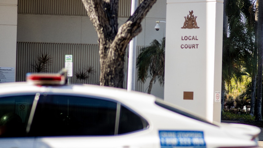 A NT Police car parked by the side of the road, outside the Darwin Local Court.