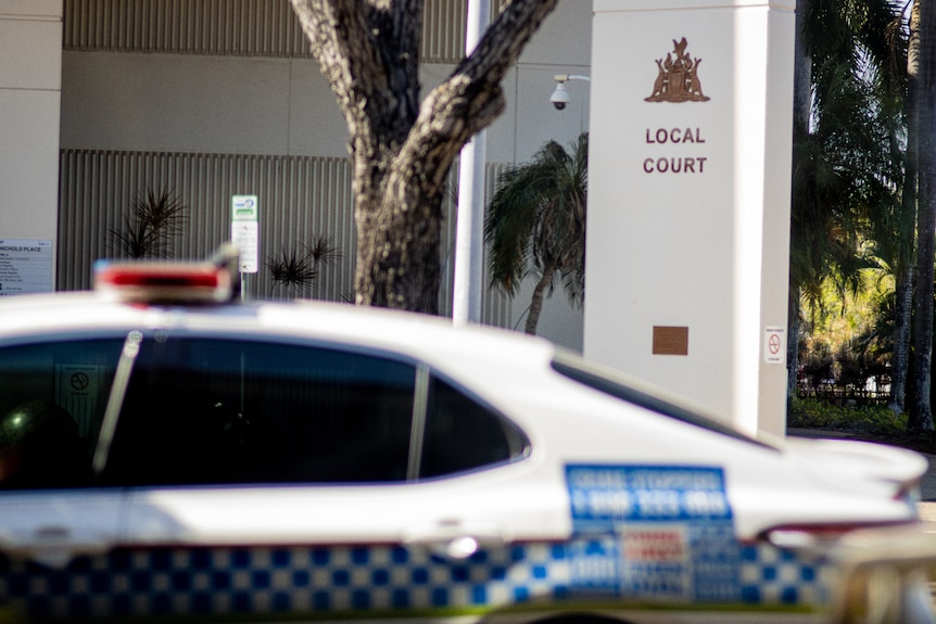 A NT Police car parked by the side of the road, outside the Darwin Local Court.