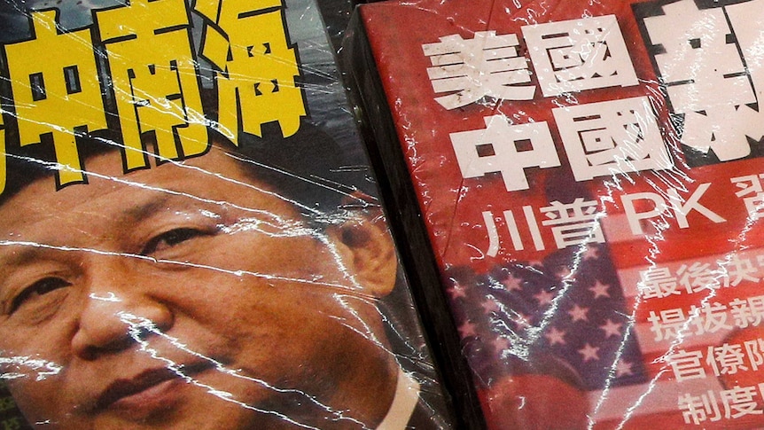 A close up of two magazine covers, one with the picture of Chinese President Xi's face on it