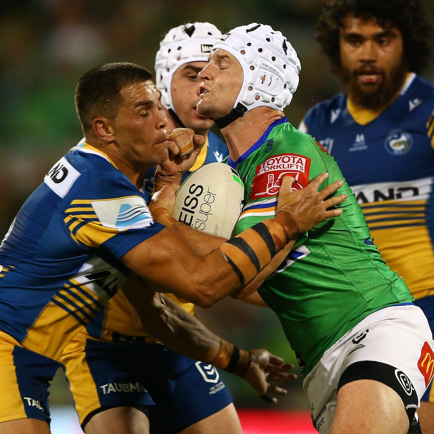 An NRL player is tackled during a match 
