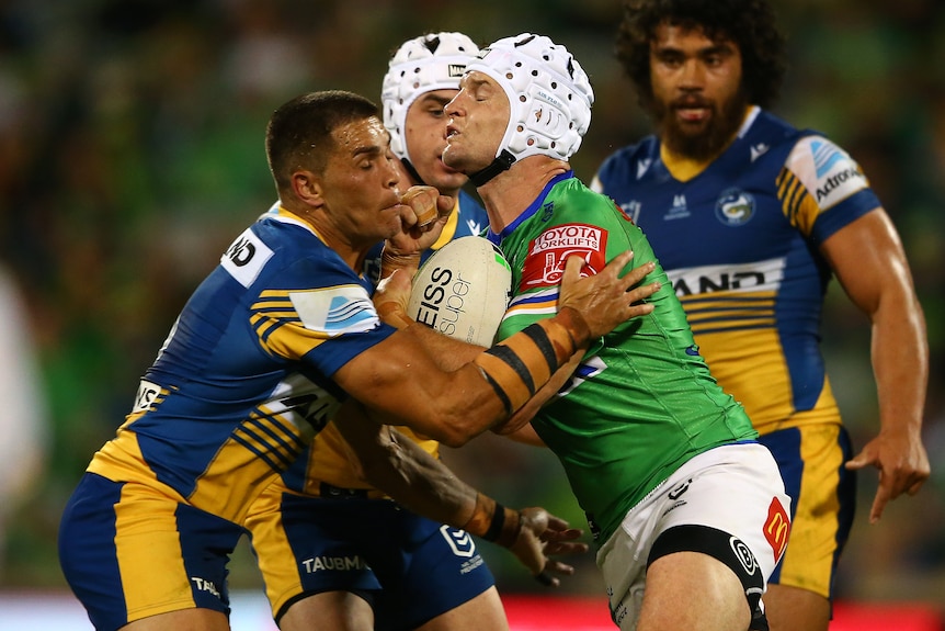 An NRL player is tackled during a match 