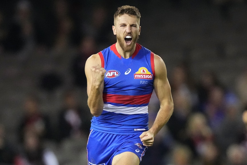 A Western Bulldogs AFL player pumps his first as he celebrates a goal against St Kilda.