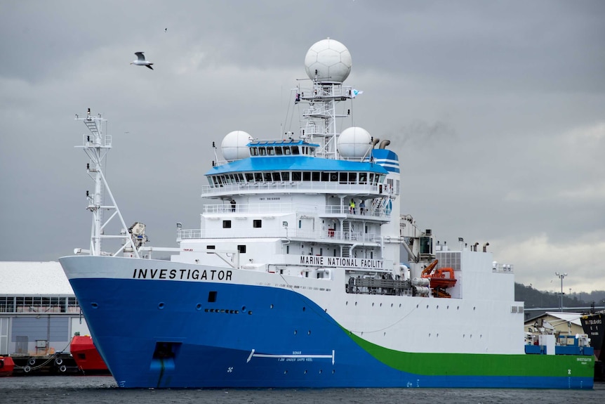 A large ship, painted blue, green and white, with 'investigator' and 'marine national facility' printed on the side