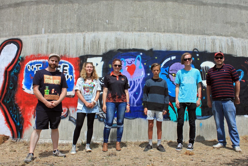 The artists in front of the water tank