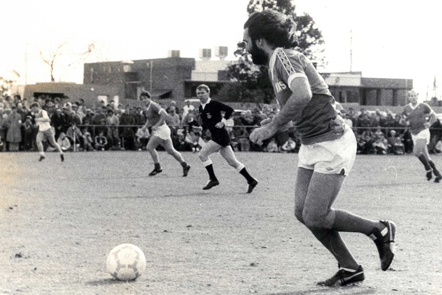 A black and white photo of George Best playing in Perth.