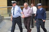 Convicted killer Klaus Neubert leaves the Supreme Court of Tasmania in Hobart.