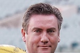 Tight shot of Eddie McGuire with Sherrin in hand