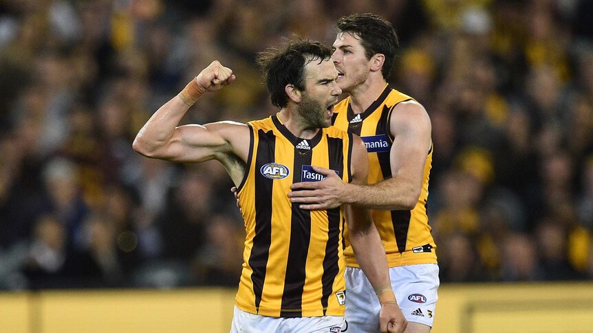 Jordan Lewis (L) and Isaac Smith of Hawthorn react after Lewis' goal against Richmond at the MCG.