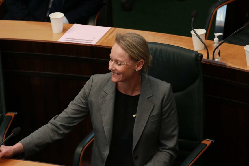 Health Minister Sarah Courtney smiles during a vote on voluntary assisted dying in Tasmania's Parliament.