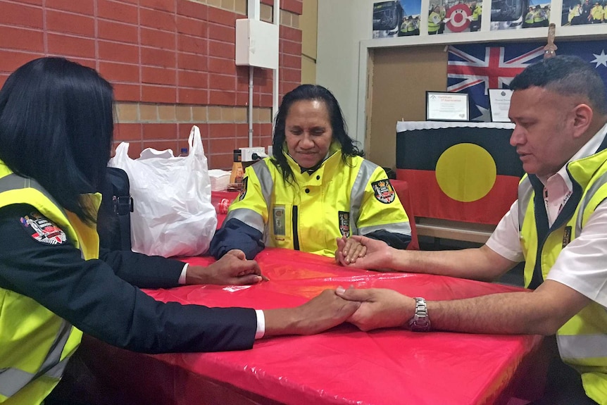 The Maori wardens pray together before heading out on patrol in Werribee.