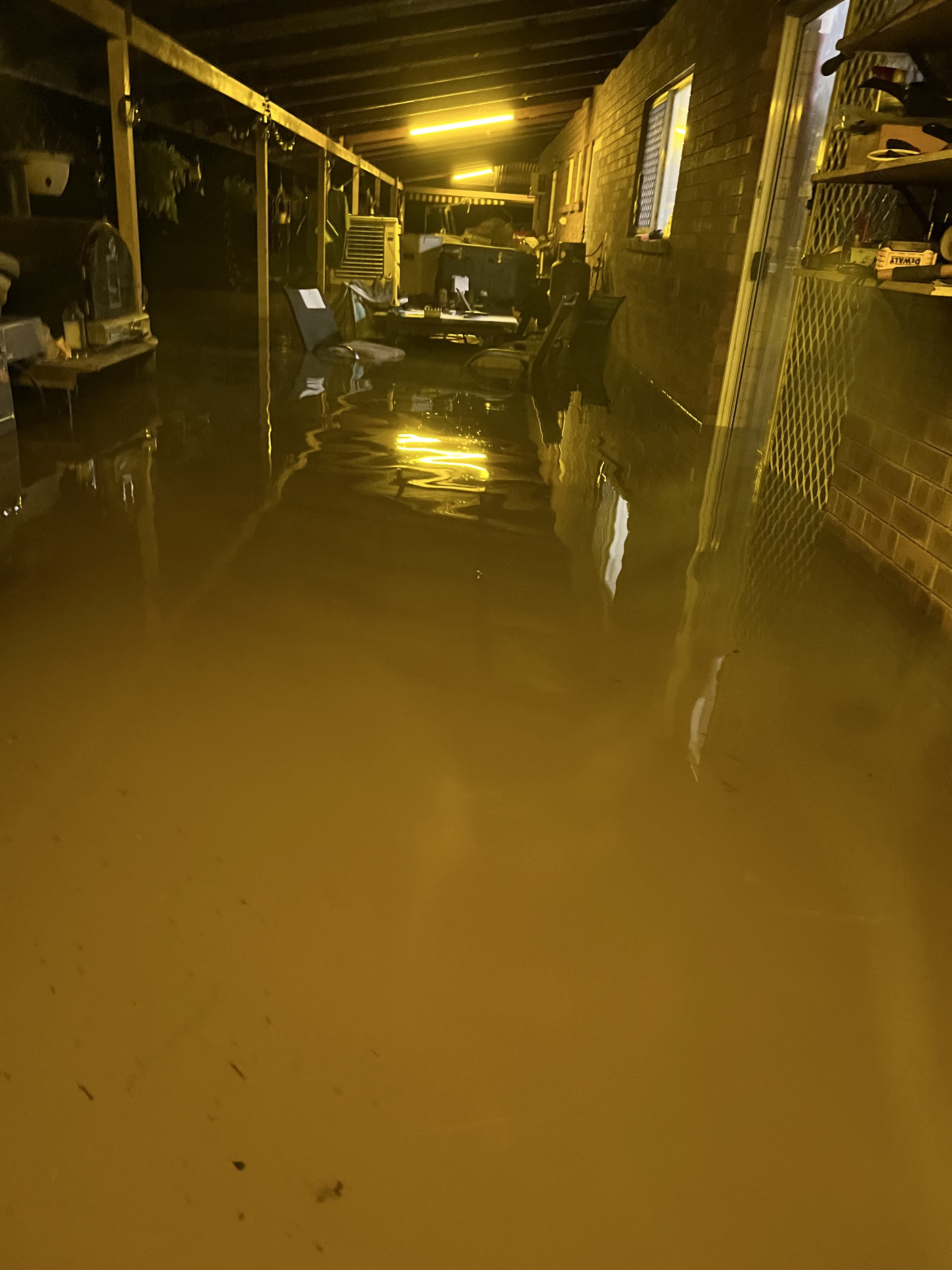 Floodwater inundates a home's verandah.