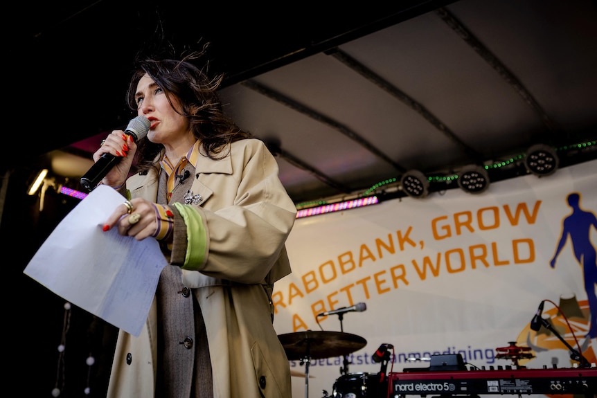 Dutch actress Carice van Houten speaks into a microphone from a stage.