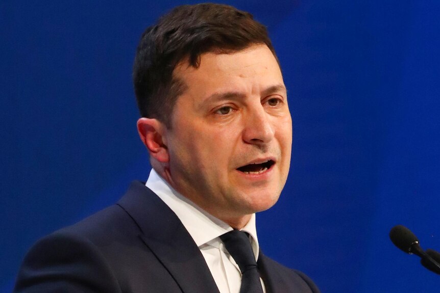 Ukraine's President Volodymyr Zelenskyy in a suit speaks during the 50th World Economic Forum in Davos