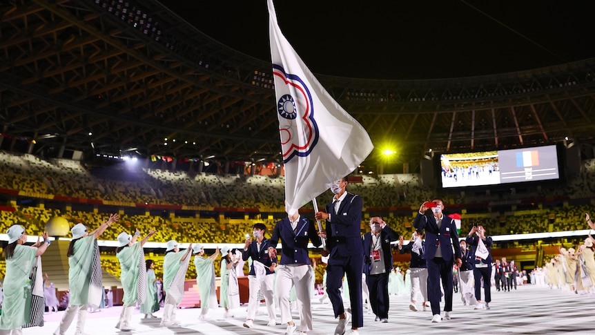 Taiwan flag bearers lead their contingent during a parade at the opening ceremony.