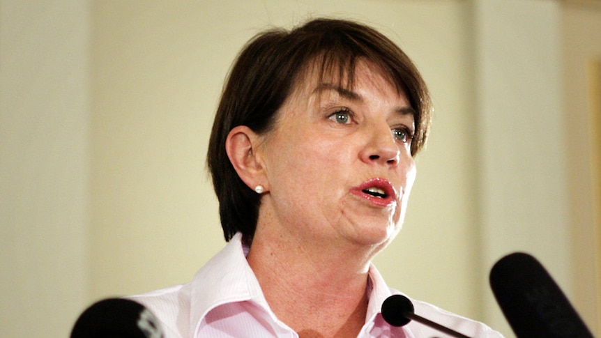 Anna Bligh has defended her Government's decision not to lower dam levels before the flood.
