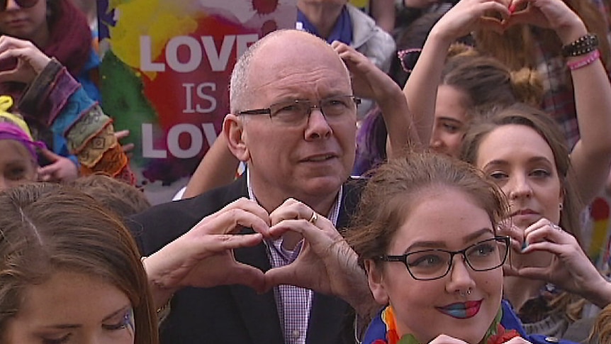 Liberal MP David Pisoni makes a heart symbol with his hands during a marriage equality rally in Adelaide, July 25 2015.