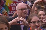 Liberal MP David Pisoni makes a heart symbol with his hands during a marriage equality rally in Adelaide, July 25 2015.